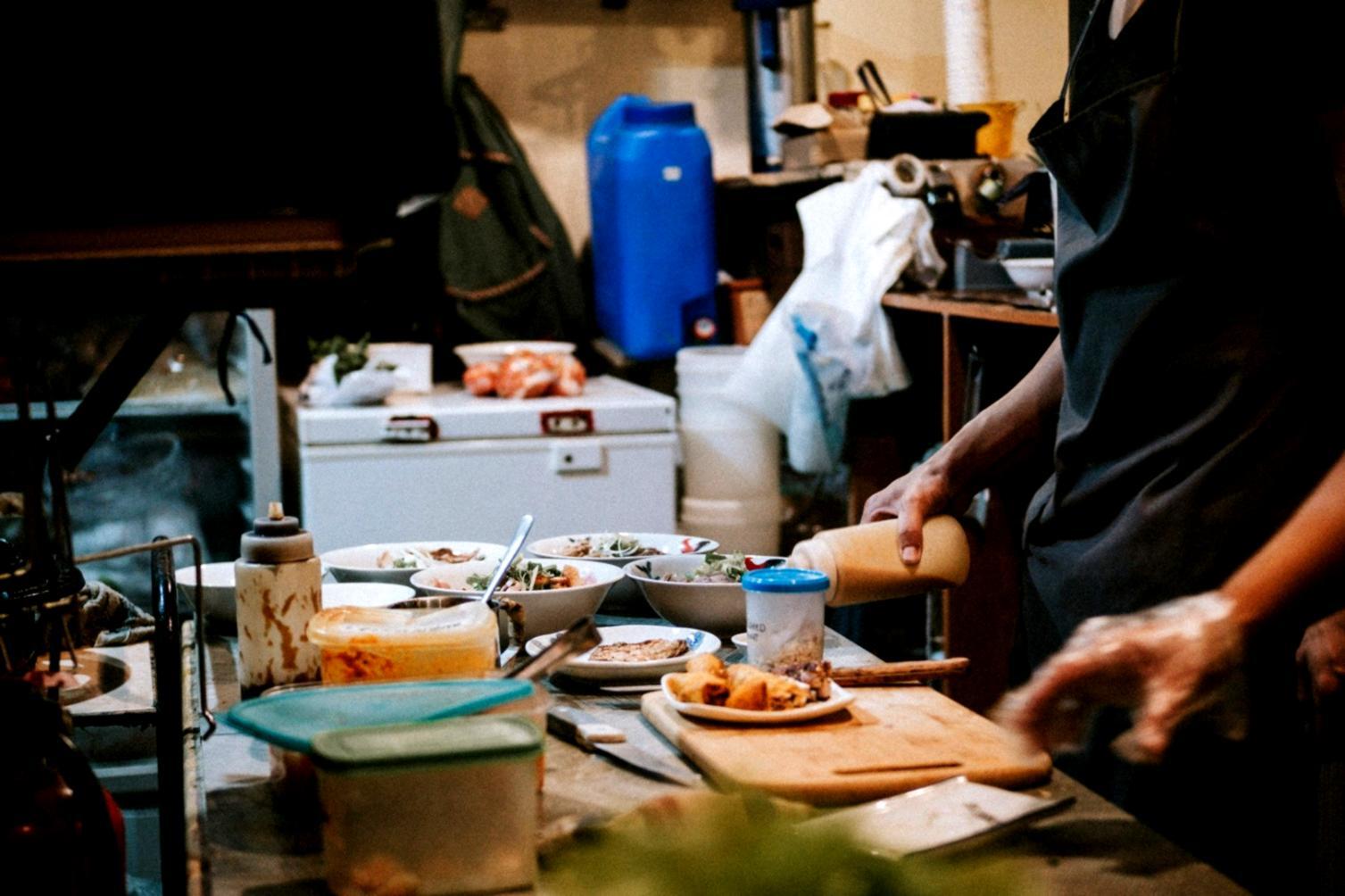 Street food workshop participants working on hands-on cooking assignments